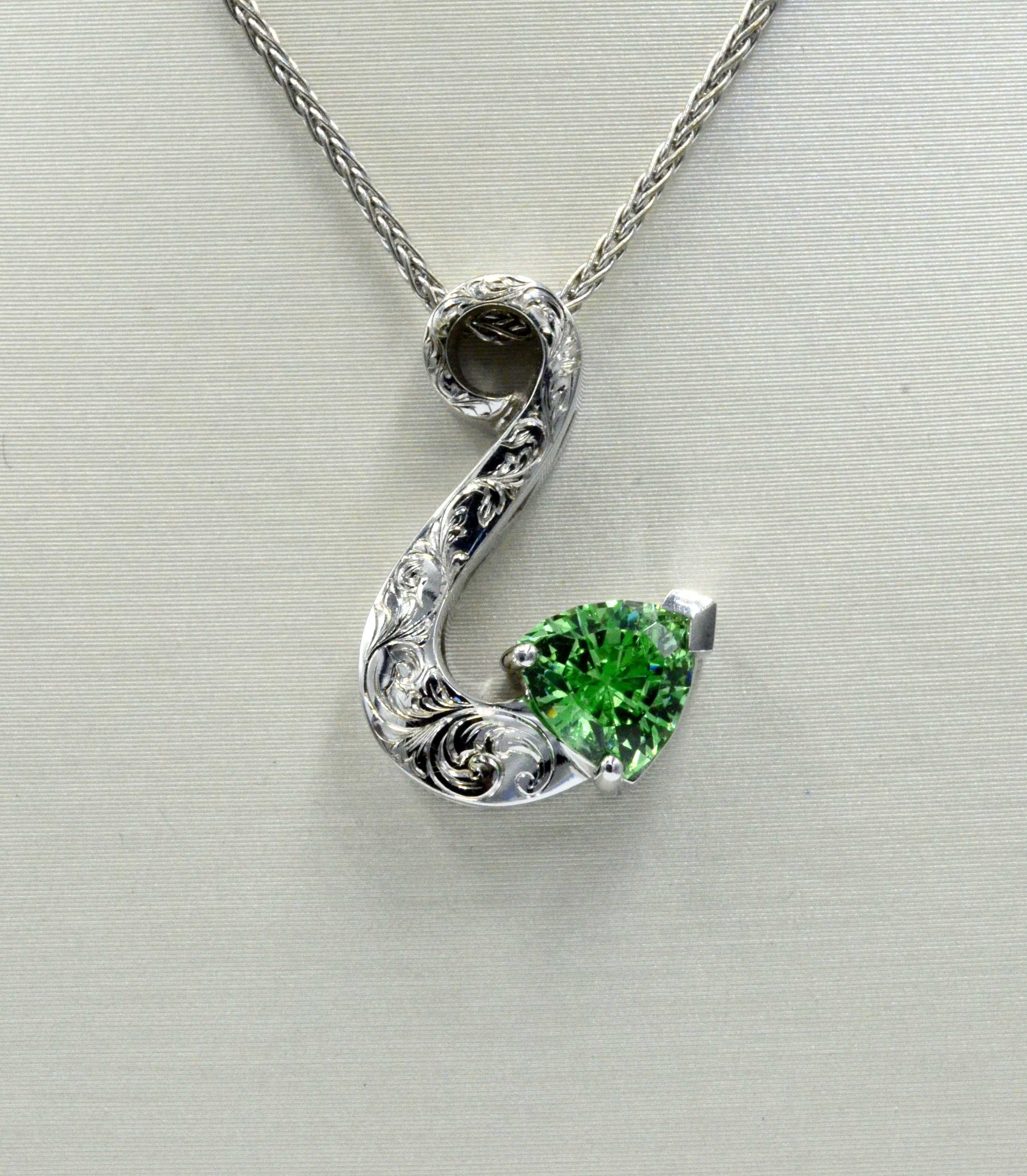 I purchased this gemstone as a rough crystal in Africa. Rich and vibrant color. Pendant is accented with hand engraving